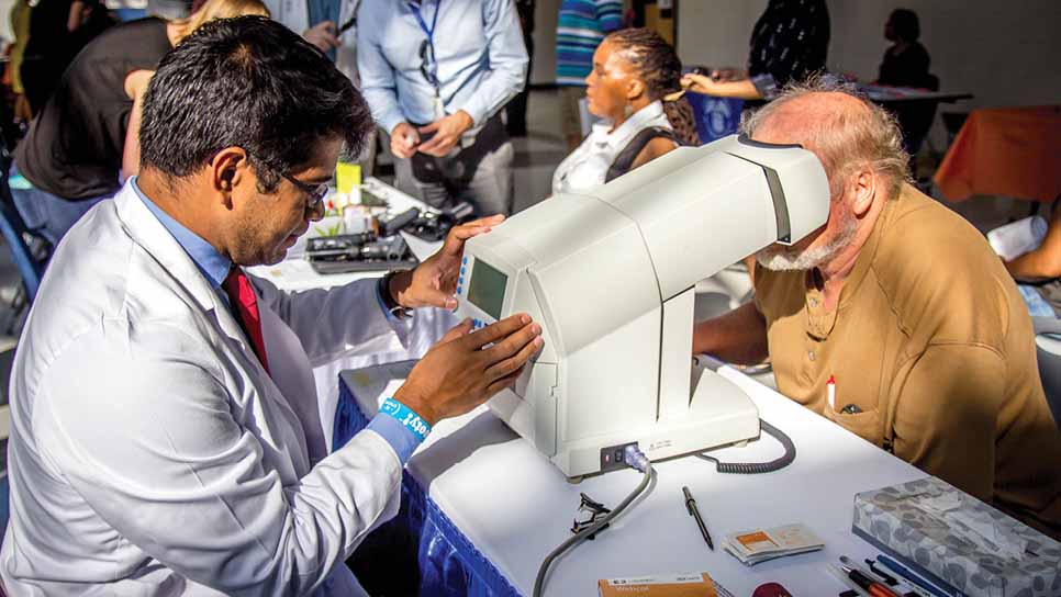 doctor checks a man's vision 