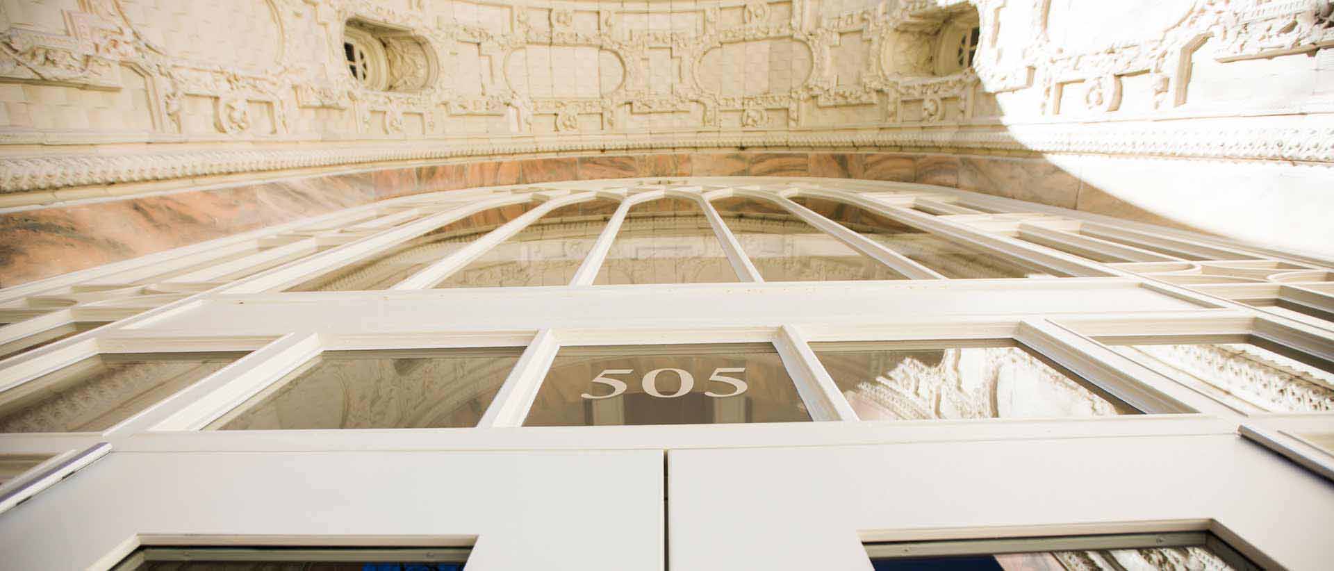 facade of ornamental building with pink marble arch