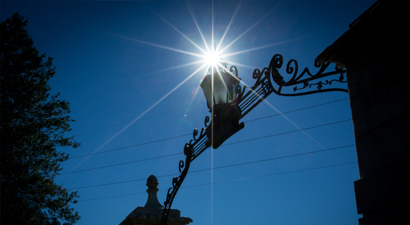 Sun shining through the arch of Emory University's Gate