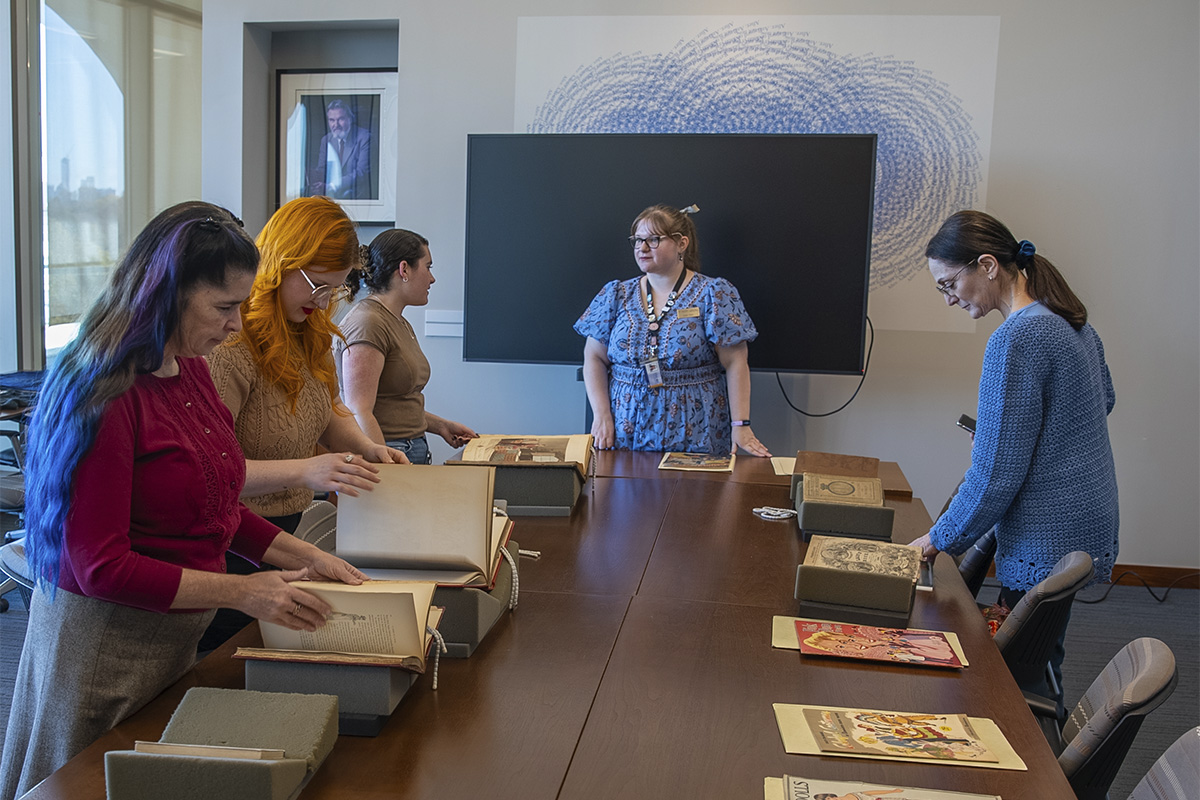 people at table viewing historic documents