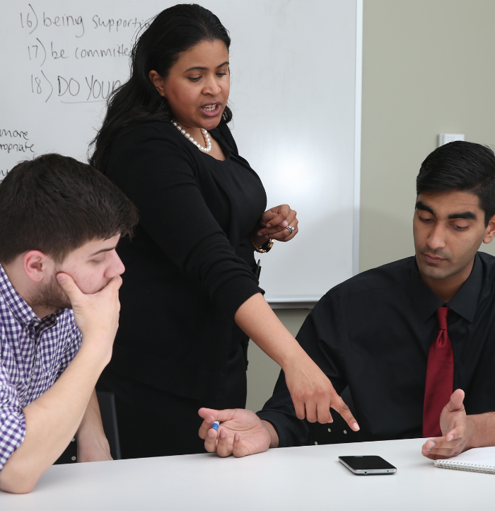 Professor talking with two rhetoric students 